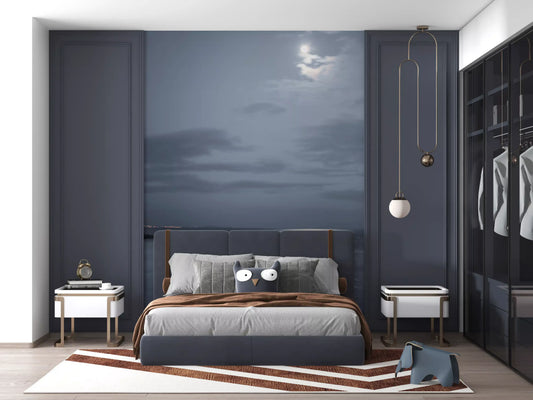 Moonlit Ocean Serenity wall mural set behind a bed in a deep blue bedroom