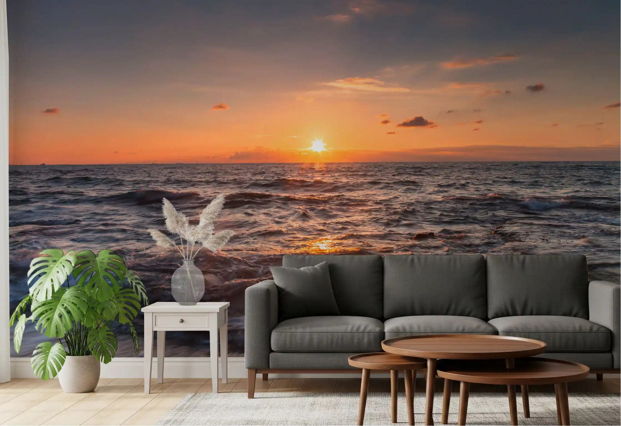 Living room set beneath a glowing Golden Horizon sunset sea wall mural