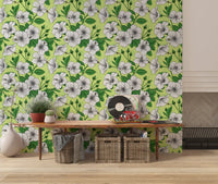 White hibiscus florals scatter across a pale lime base in this vintage Aloha wallpaper