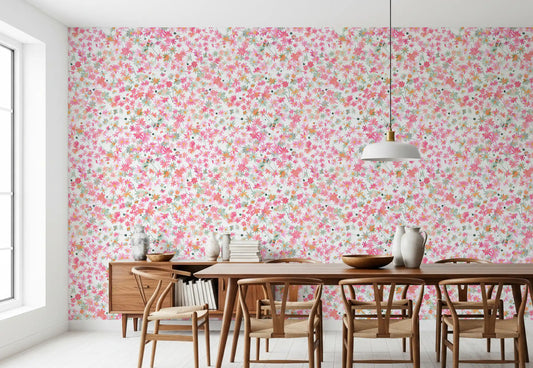 Pink, coral and peach florals cover the dining room in Daisy Dance wallpaper