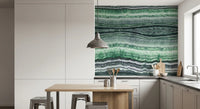 Mineral layering in green, white and charcoal across the wall mural surface.