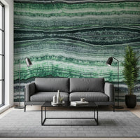Green Jade Veins wall mural behind a grey sofa in a bright living room.