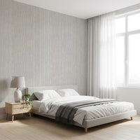 Threaded vertical lines stretch through a Bedroom on the Linen Serenity wallpaper