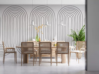 Dining room area set against a fine arch-line wall mural in chalky off-white