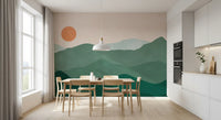 Sage ridges and an orange sun fill the Green Peak Sunset wall mural in a dining room