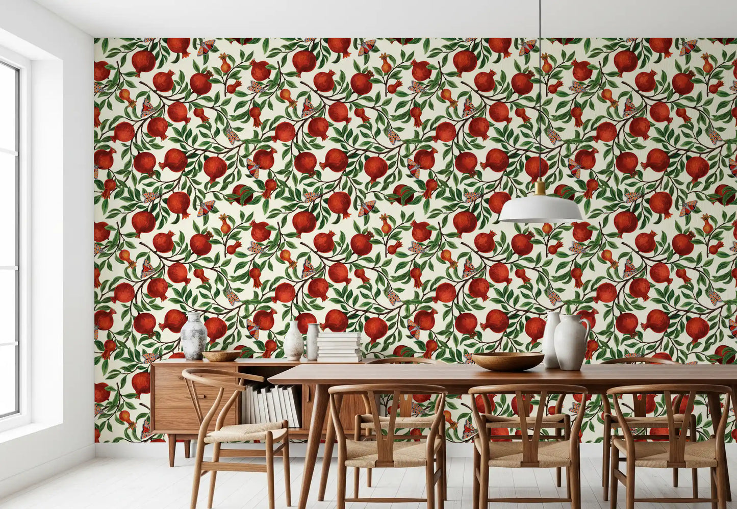 Painterly clusters of red fruit and moths sit across the Pomegranate Orchard wallpaper.