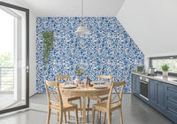 A floral repeat in Wild Roses wallpaper finishes a kitchen dining area.