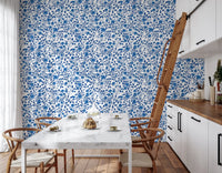 Petals and buds stretch over ivory ground in Wild Roses and White wallpaper