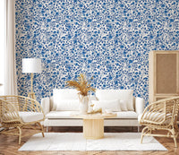 Each motif shows a bloom and small leaf in this Wild Roses Blue wallpaper.