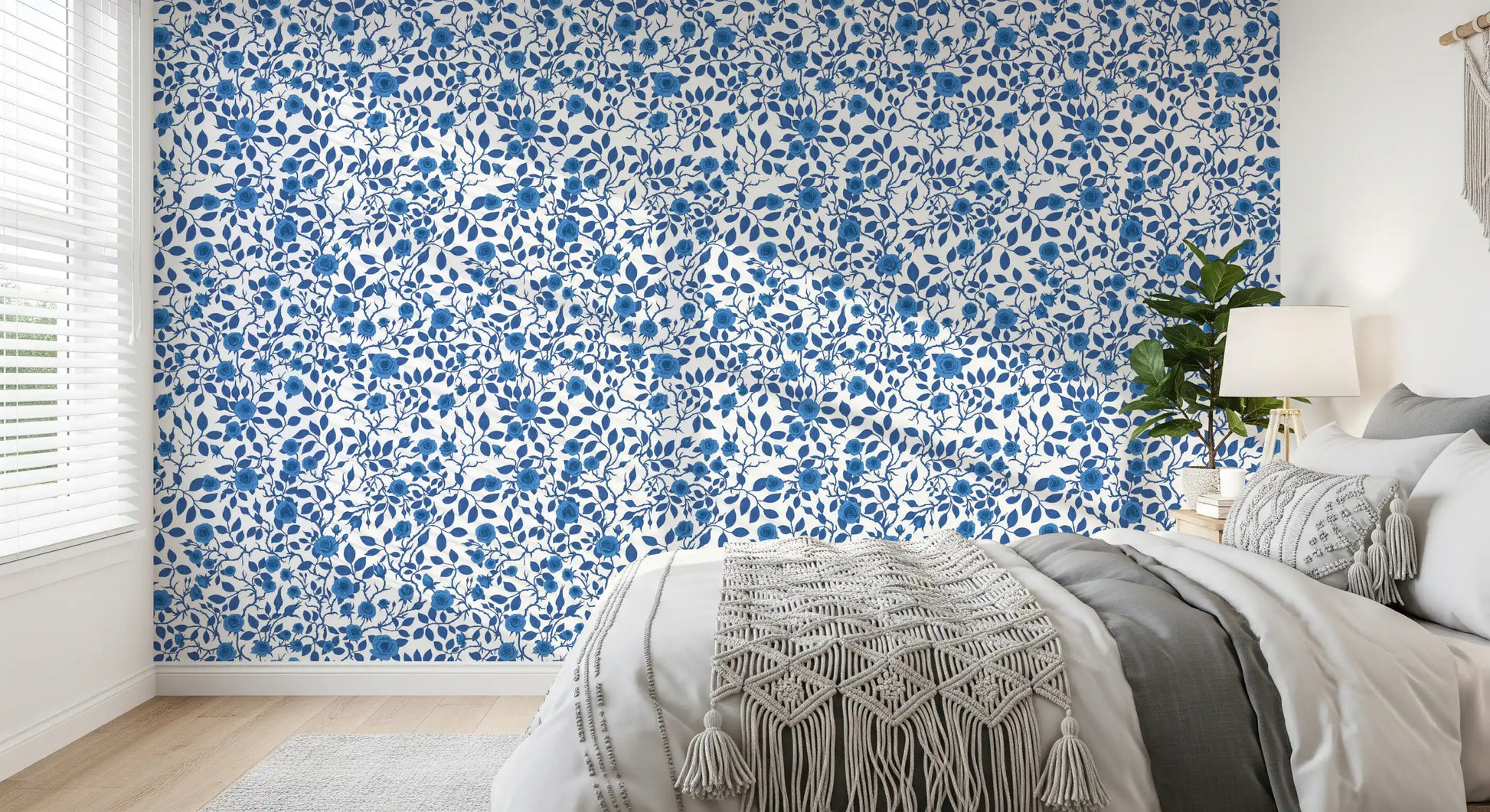 Indigo roses cluster along thorned stems in this Wild Blue and White wallpaper.