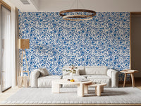 Twisting vines wrap rounded blooms across the  Roses Blue and White wallpaper.