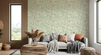 Cream ground holds pale roses, green leaves, and thorny stems in this briar wallpaper.