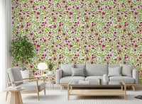 Pink florals and green vines wrap a living room on this Blooming Rose Trellis wallpaper.