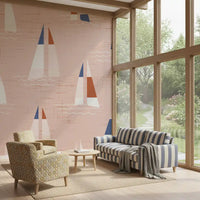 A coastal feel relaxes the living room thanks to the peach Sailboats wall mural.