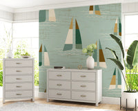 A coastal vintage mood lifts a home Living room with Mid Century Sailboats wall mural touches.