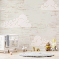 Pale clouds rest above a nursery space with the Mid Century Cloud Cream wall mural.