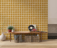 Lounge calm grows beside the Mid Century Wavy Grid Mustard wallpaper's loose check.