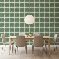 Green check squares sit inside a wobbly cream lattice on this Wavy Grid Sage wallpaper.