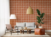 Uneven check lines weave across a Living room wallpaper in terracotta and cream.