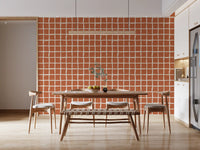 Warm terracotta squares and wonky cream channels frame a Dining area wallpaper feature.