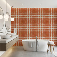 Mid Century Wavy Grid Terracotta wallpaper warms a bathroom with earthy clay tones.