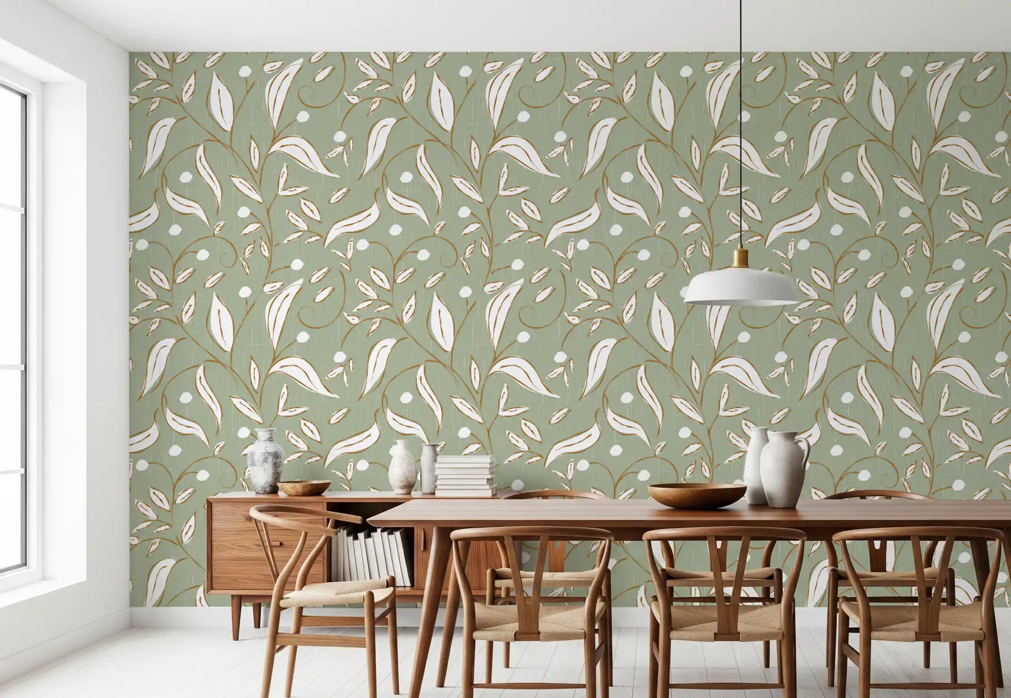 Sage green botanical vine wallpaper lining a relaxed Scandinavian dining room