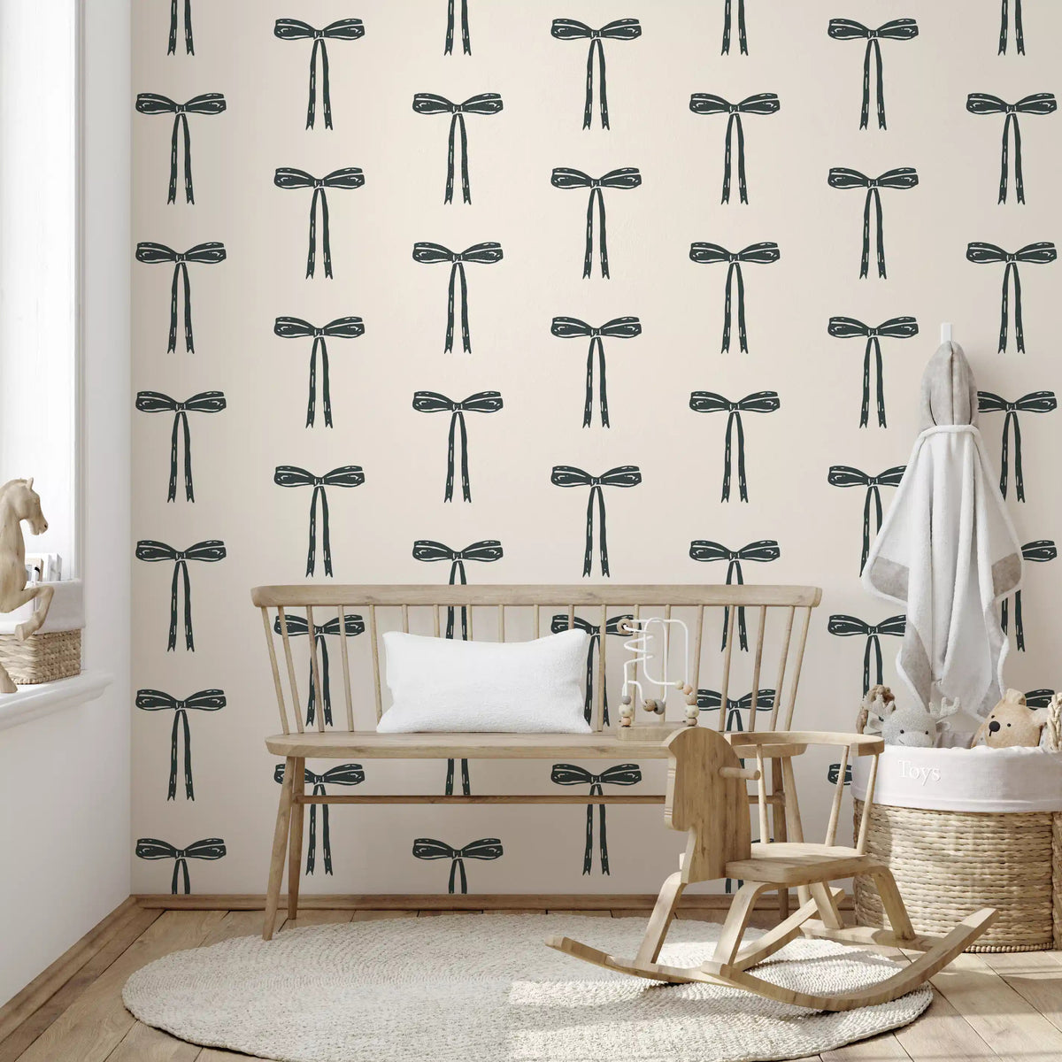 Charcoal bow motif wallpaper spaced across a nursery backdrop, GD11929
