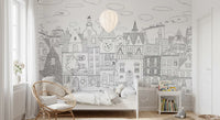 Cat cityscape wall mural with a hot air balloon behind a rattan peacock chair and white bed GD12396