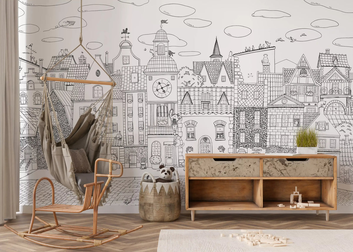 Monochrome cityscape mural behind a rattan swing chair and wooden console in a play nook GD12396