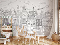 Cat cityscape wall mural behind a play table with bunny-ear chairs and a white crib GD12396