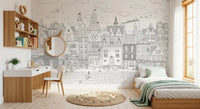 Cityscape wall mural in a child's room with white desk, round mirror and mint bed throw GD12396