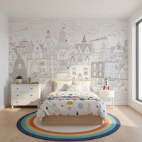 Line-art village mural behind a bed with confetti dot bedding and a rocket toy nightstand GD12397