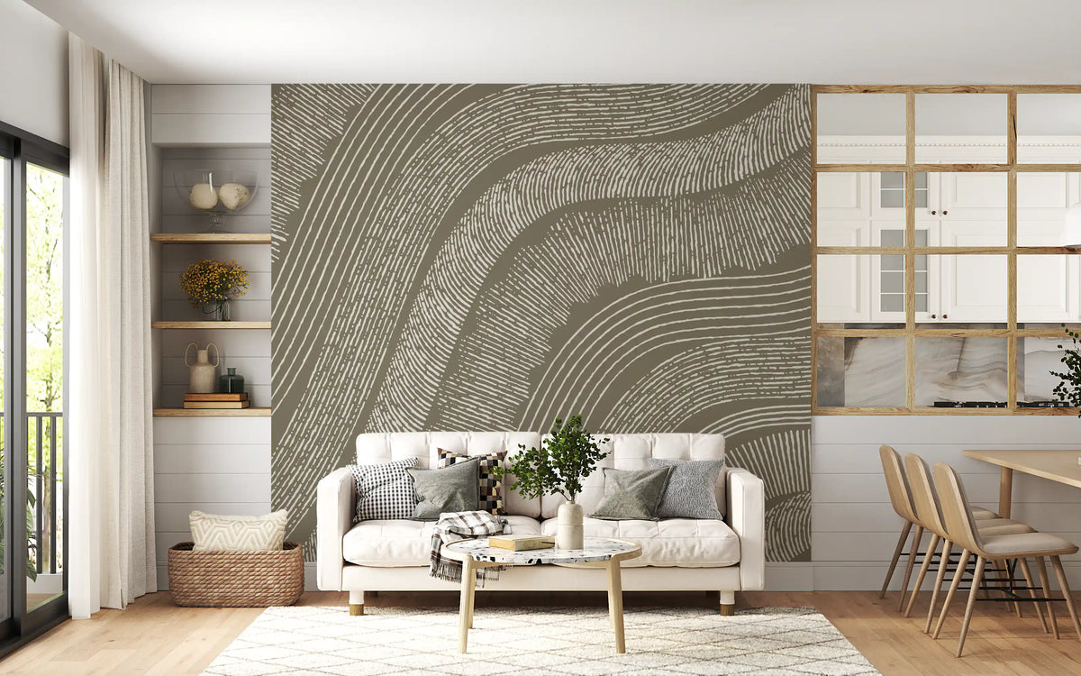 Taupe wavy etched lines mural behind a cream sofa with wooden dining chairs and shelving GD12471