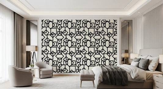Monotone geometric wallpaper in a bedroom with a grey throw and floor lamp GD12499