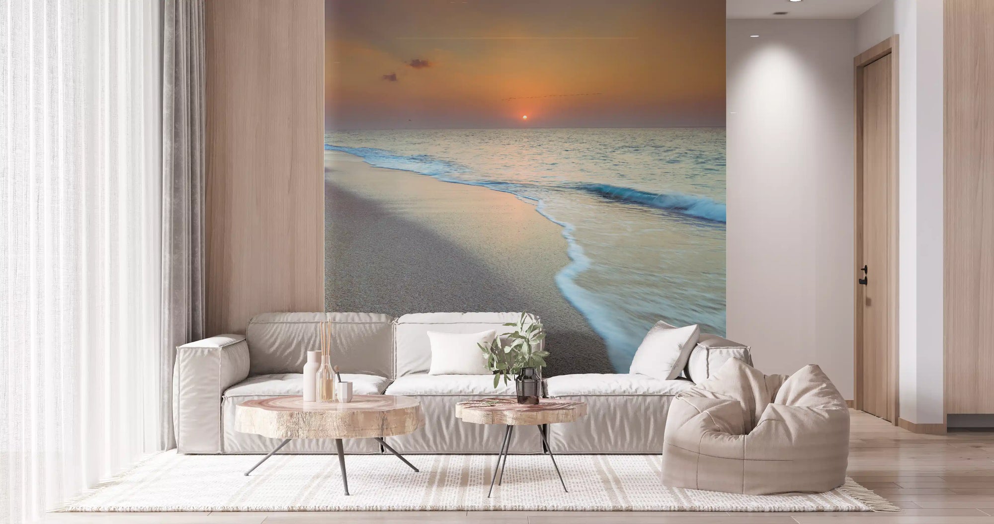 Golden hour coastal mural behind a white sofa with a beanbag and round tables GD12790