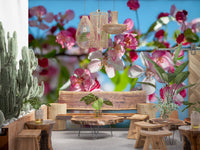 Panorama mural de branches fleuries roses sur fond bleu ciel
