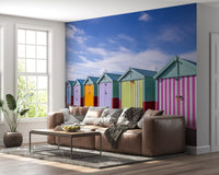 Striped huts mural behind a brown leather sofa and metal coffee table GD13132