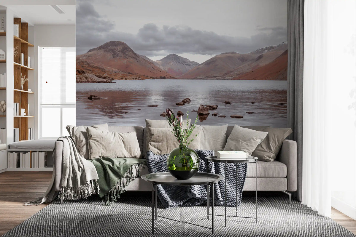 Lake wallpaper behind a beige sofa with throws and wooden shelves GD13143