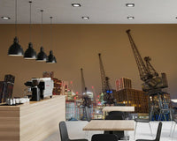 Warm brown city mural in a cafe kitchen with coffee machine, black pendants and wood tables GD13146