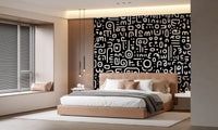 Monochrome geometrische Kritzel-Symbole auf schwarzem Wandbild