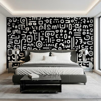 Monochrome geometrische Kritzel-Symbole auf schwarzem Wandbild
