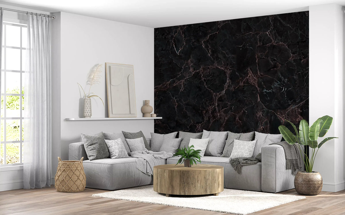 Black marble wallpaper behind a light gray sectional sofa and round wood coffee table GD14022