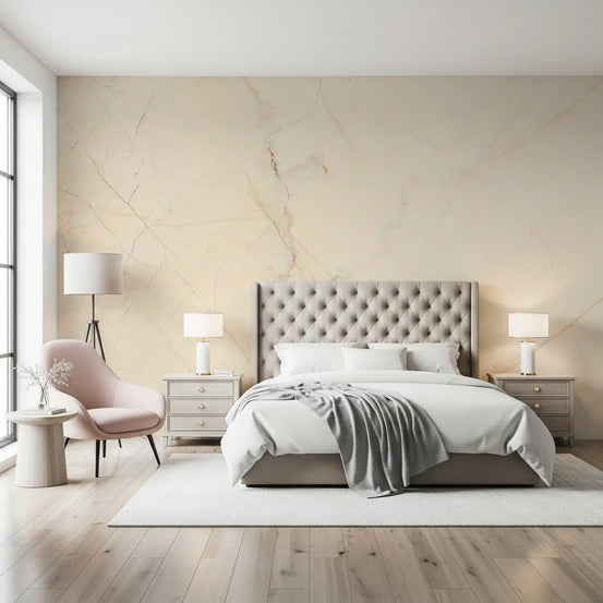 Bedroom with tufted headboard, white bedding and pink chair on cream marble wallpaper GD14029