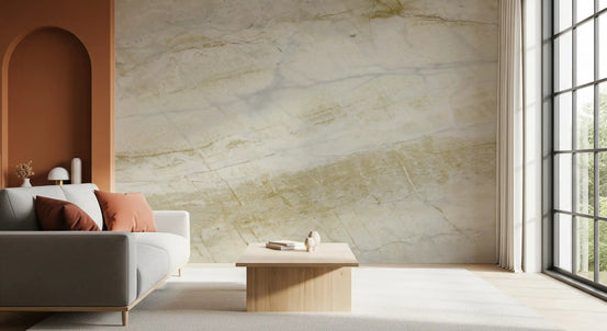 Gray sofa with rust cushions beside a terracotta arch on golden veined marble wallpaper GD14055