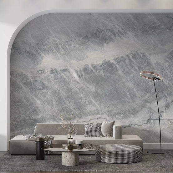 Arched alcove with low gray sofa, round tables and ring floor lamp on gray marble wallpaper GD14065