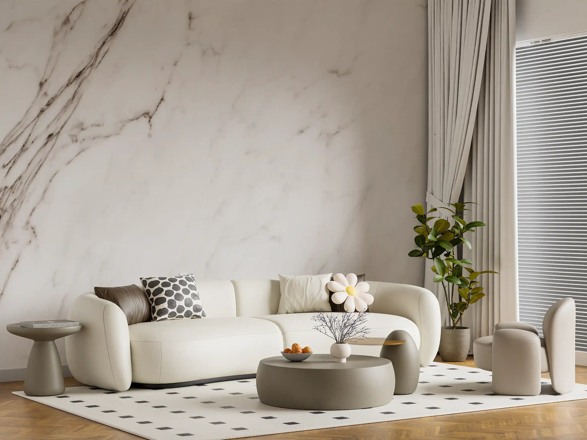 White marble wallpaper mural behind cream curved sofa and dotted rug GD14088