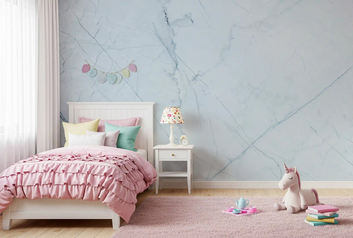 Girls bedroom with pink ruffled bed, unicorn toy and pink rug on pale marble wallpaper GD14146