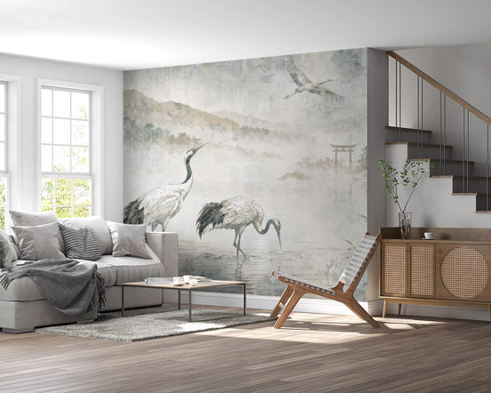 Crane wallpaper mural behind a gray sofa and rattan cabinet in a bright living room GD14198