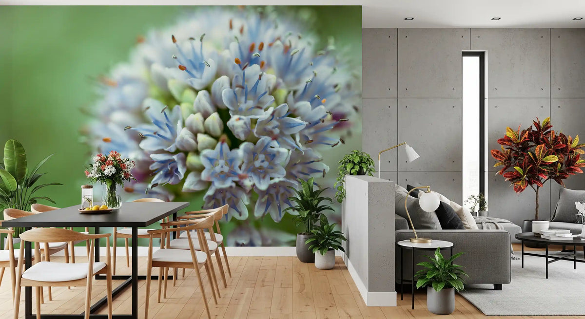 Open dining and living room with a black table and gray sofa on a blue flower mural GD14202