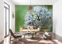 Rattan loveseat and macrame pendant on terracotta tiles in front of an allium mural GD14202
